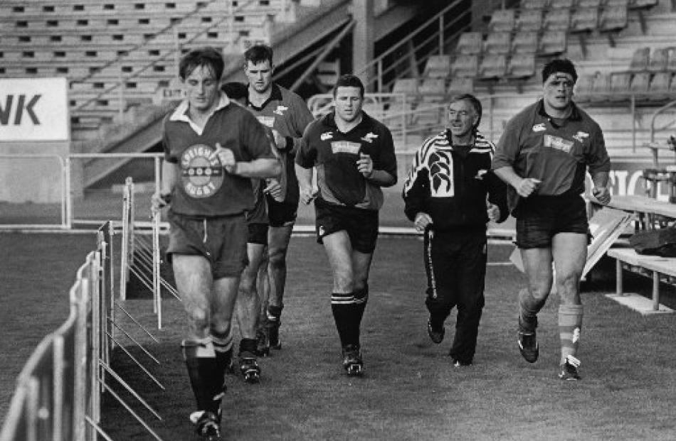 All Black coach Laurie Mains (second from right) trains with All Blacks (from left) Paul...