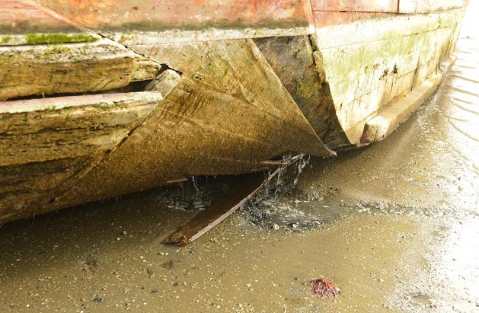 Water pours from the hull of  Portland.