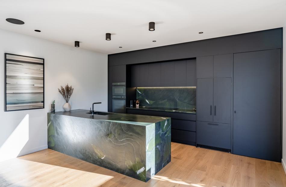 The natural stone on the island bench and splashback is Avocatus, in a leathered finish. Its deep...