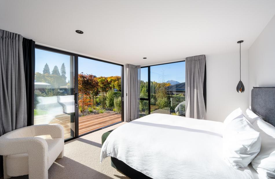 Two of the bedrooms open to the outdoor entertainment area. The black "seed pod" pendants by the...