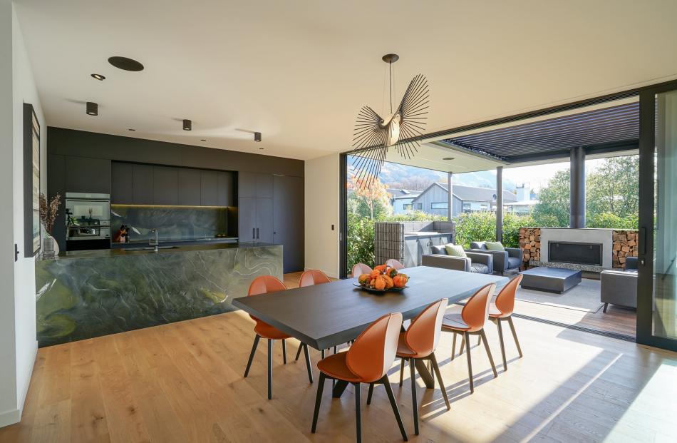 Desejo’s "Space" light made from carbon anodised steel hovers over the dining table. PHOTO:...