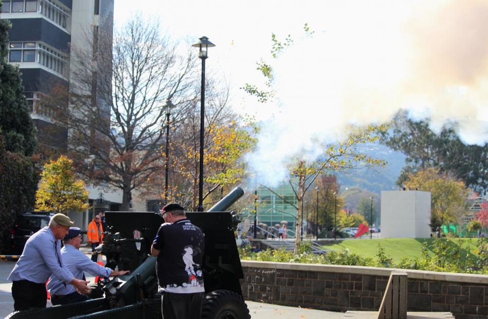 A two-gun salute from a 25-pound field gun echoes across the university.