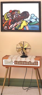 A restored fan sits on a pianorgan III, a 1950s electric keyboard that is owned by one of Dr...