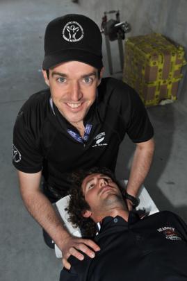 Chiropracter Robert More, from Cromwell, works on driver Ryan Heagney, from Blenheim, in the pits.