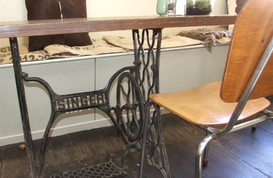 A Singer sewing machine base has been used to create a table.