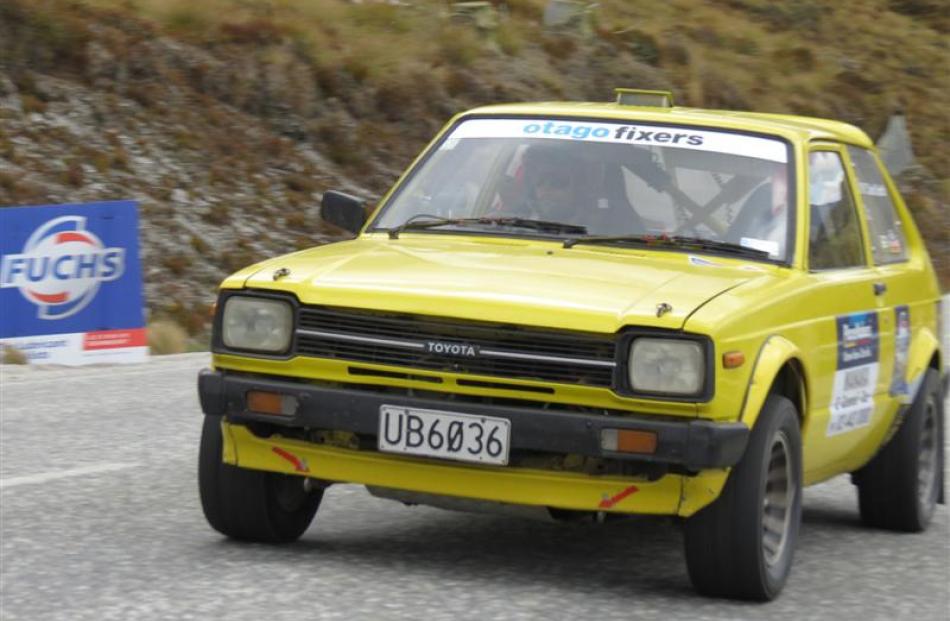 Driver David Smith guns the engine of his Toyota after clearing a hairpin bend.