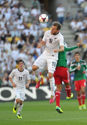 Jeremy Brockie and Mexico's Raul Jimenez with NZ Marco Rojas in support New Zealand.