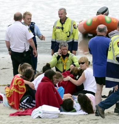 Columba College pupils huddle together after being rescued. Photos by Peter McIntosh.