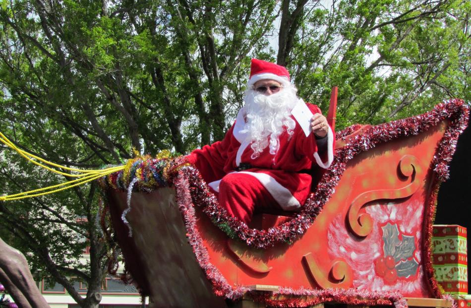 Santa waves to the crowd at the Oamaru Christmas Parade.