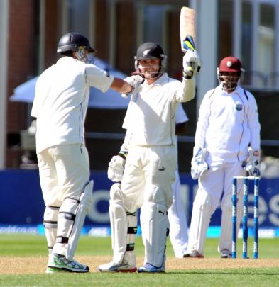 Brendon McCullum celebrates his 50 with Ross Taylor on day one of the first test between New...
