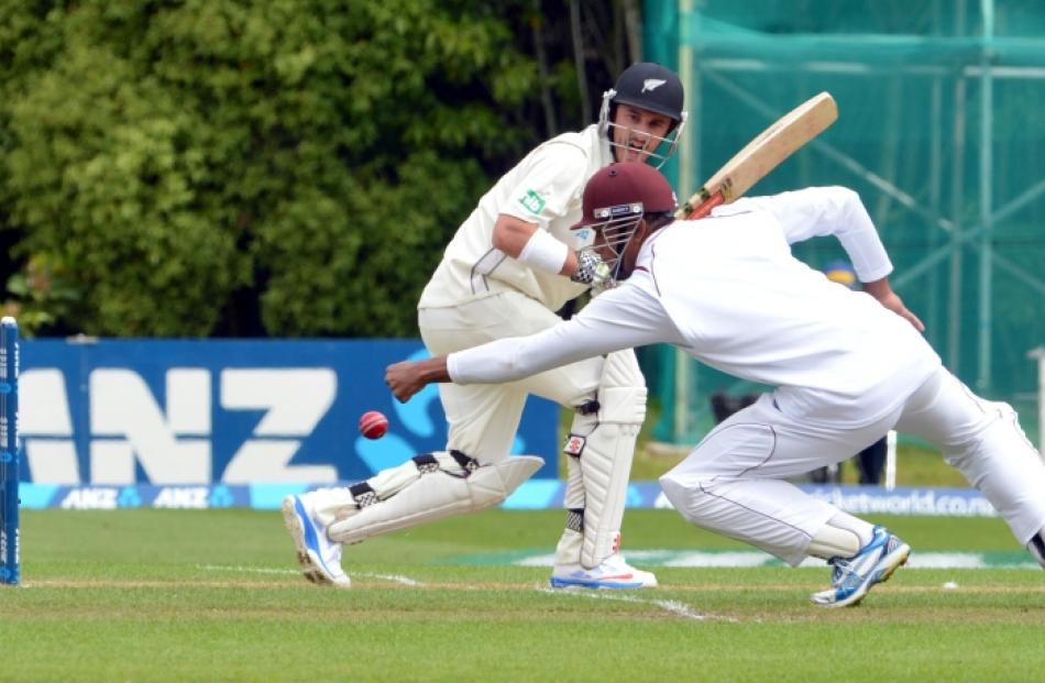 Hamish Rutherford cuts the ball past Kieran Powell during the New Zealand v West Indies cricket...