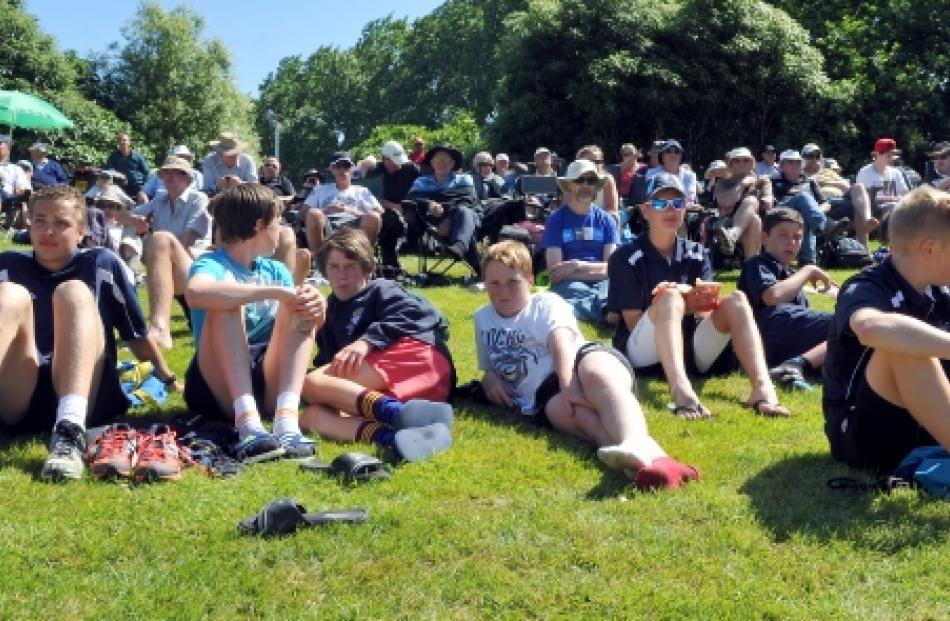 Spectators sit in the sun on day one of the first test between New Zealand and the West Indies at...