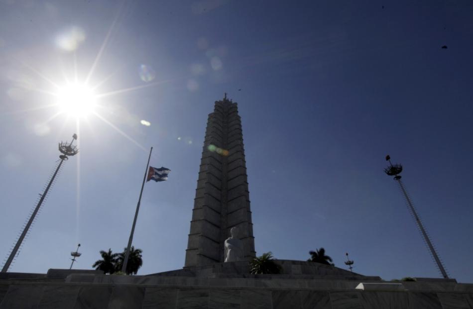 The Cuban flag flies at half mast in Revolution Square, Havana, in honor of South Africa's former...