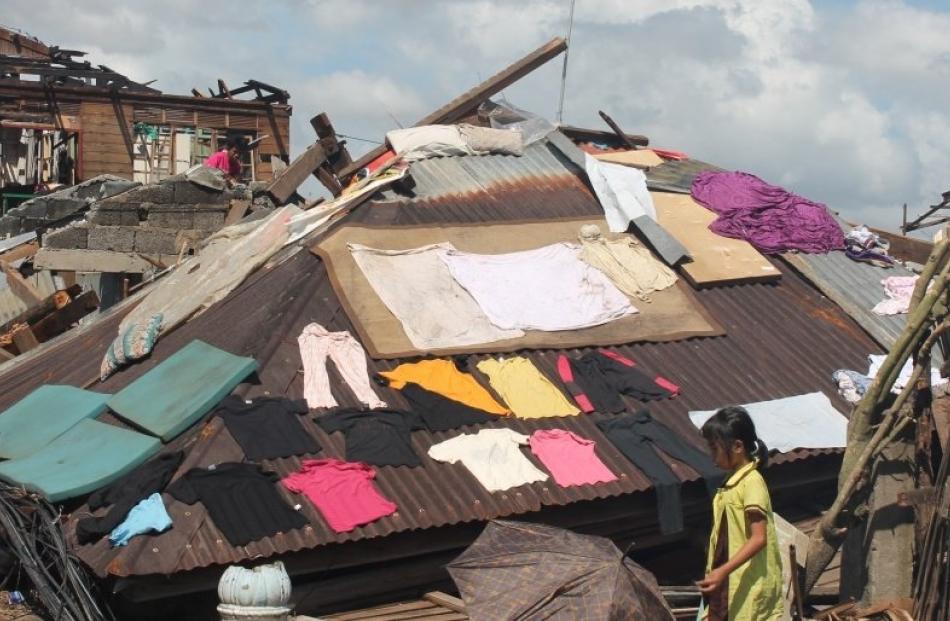 Clothes dry on the roof of a collapsed building. Photos by International Needs.