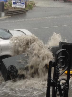 A gutter in York Pl overflows during torrential rain in Dunedin this afternoon. Photo by Irene...