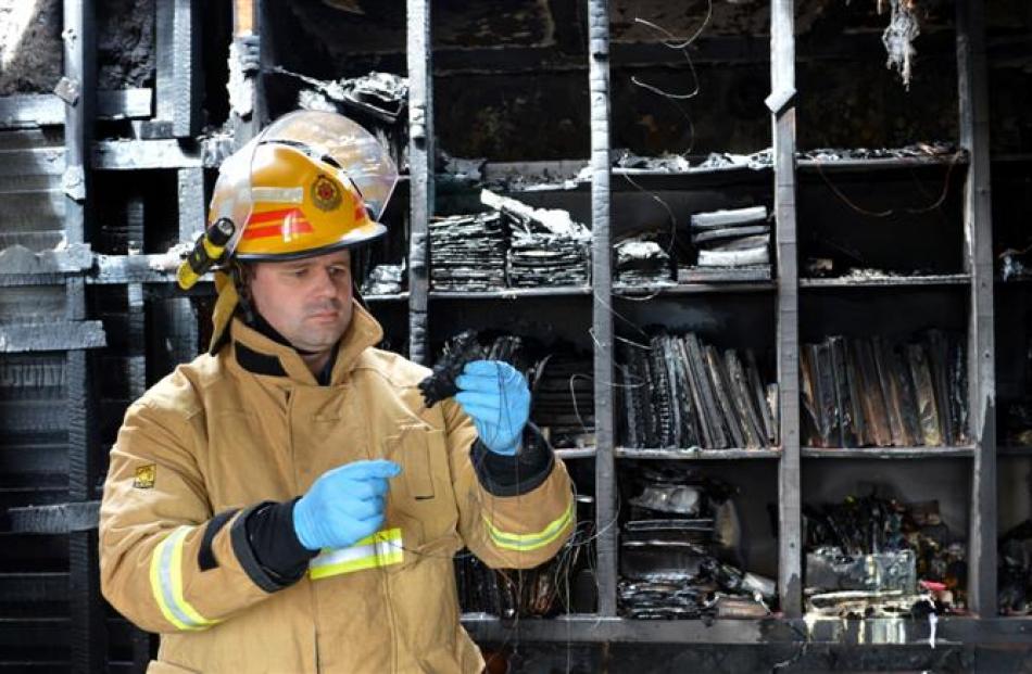 East Otago fire risk management officer Michael Harrison examines the Christmas lights power lead...