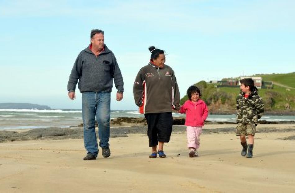 Blake and Maraea Downie walk along the beach with their daughter, Shakana (4), and grandson Tane ...