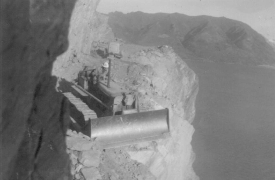 Mac Passmore pushes rock over the edge. Photo from the Charlie Cassidy Collection