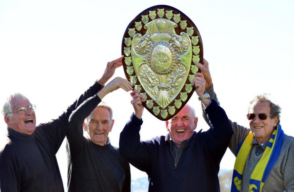 Members of the 1957 Otago team celebrate with the Ranfurly Shield at Bathgate Park earlier this...
