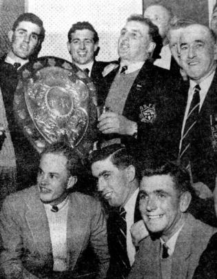 Members of the Otago team triumphantly display the Ranfurly Shield after the match at Athletic...