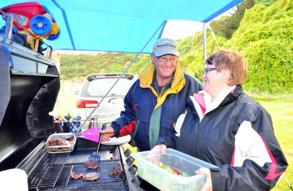 Mark and Sue Kingipotiki, of  Balclutha,  make lunch at their campsite at Toko Mouth.