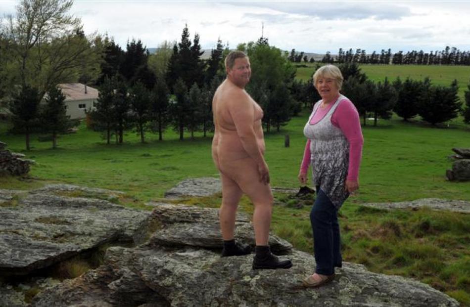 Orchard Sun Club members Joyce Mullen and Philip Matthews stand on a rocky outcrop on the club's...