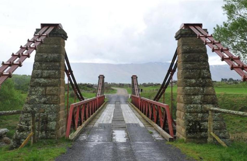 The schist block and wire rope suspension bridge across Taieri River at Sutton is 128 years old.