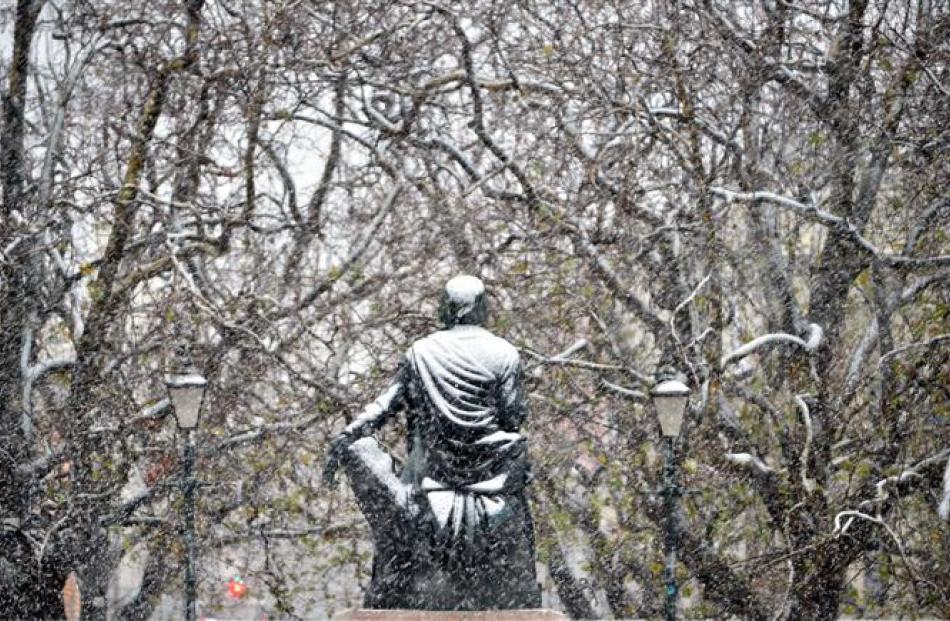 The Robbie  Burns statue in the Octagon during a May snowfall.