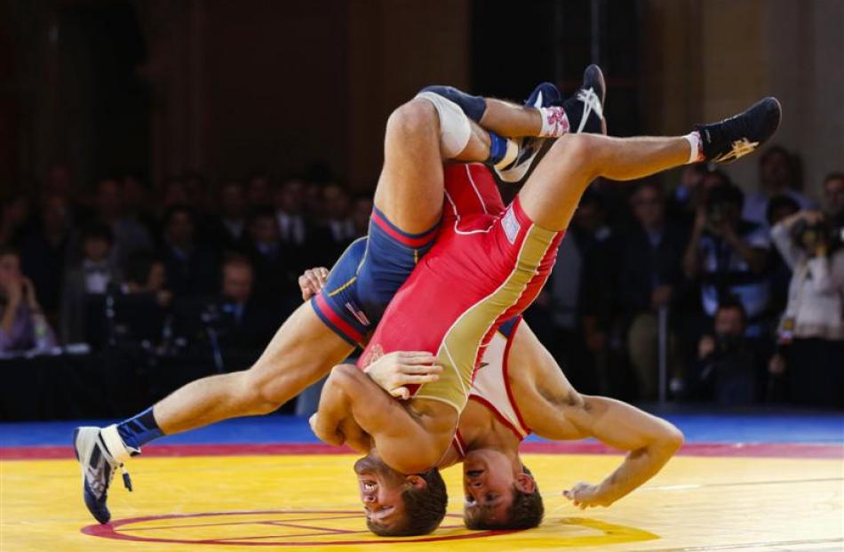 Russian Saba Khubetzhty (left) and American David Taylor  flip over on their heads during the...