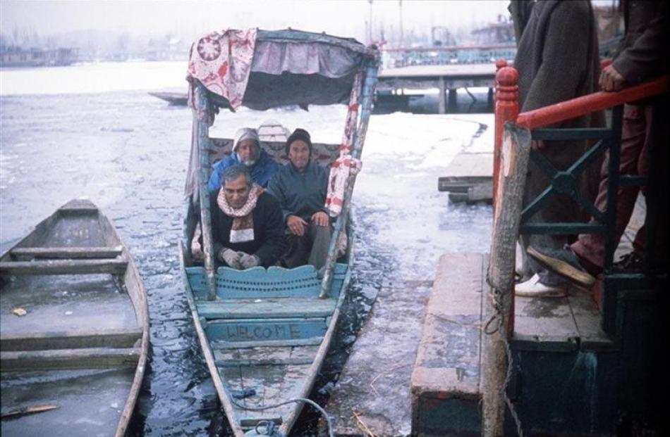 Alistair McMurran (back left) and David Horne ride a shikara on the frozen Dal Lake in Kashmir...