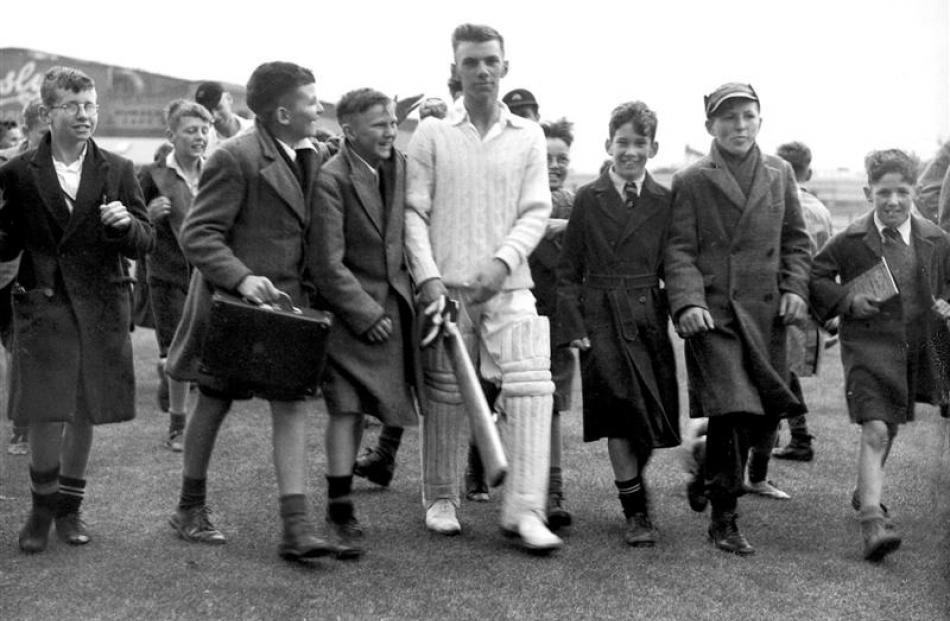 Noel McGregor walks back to the pavilion at Carisbrook after he helped score the runs which gave...