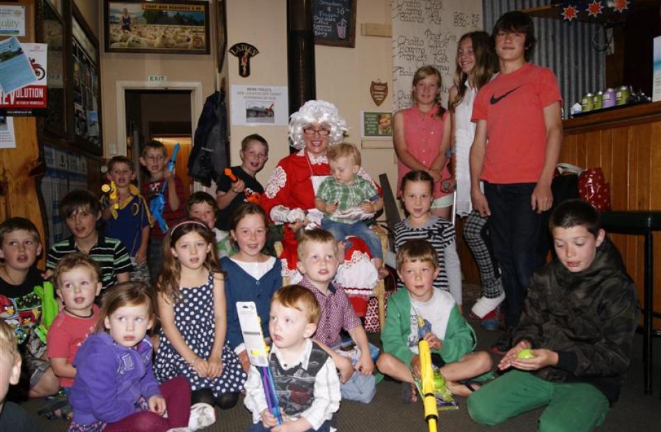Young and old alike enjoy the tavern's annual Christmas party.