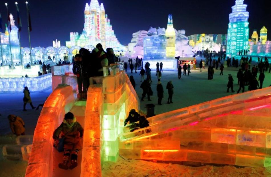 A visitor rides a slide on an ice sculpture during a light-up rehearsal. REUTERS/Kim Kyung-Hoon