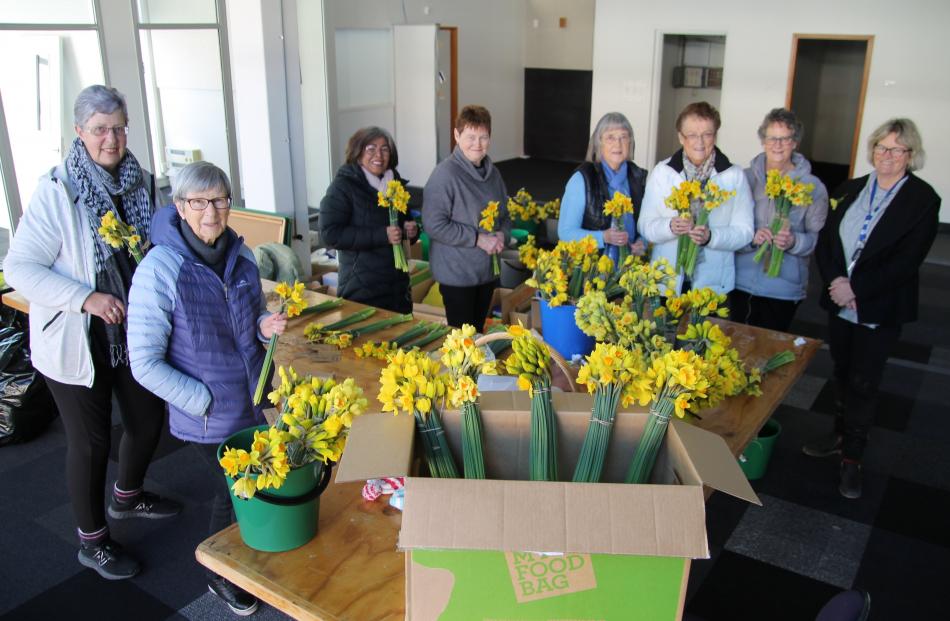 Binding bulk blooms into 170 bunches of 20 were (from left) Joyce Beck, Ann Davies, Sanong...