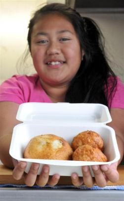 Makeila Fereti (11) displays the pork buns and pineapple bread  sold at her  parents'  food trailer.