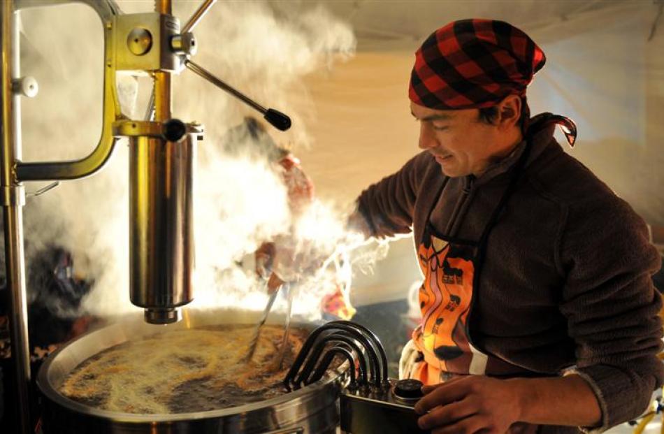 Matthew Collier prepares churros. Photo by Craig Baxter.