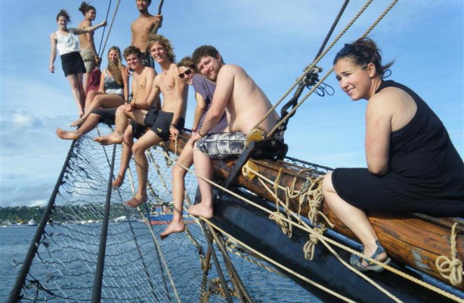 The crew hanging on the jib boom of the Alvei, happy to be arriving in Suva, Fiji.