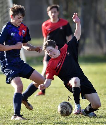 Linwood football (Dunedin) - St Kevin’s College player Riley Tuffley slips while under pressure...