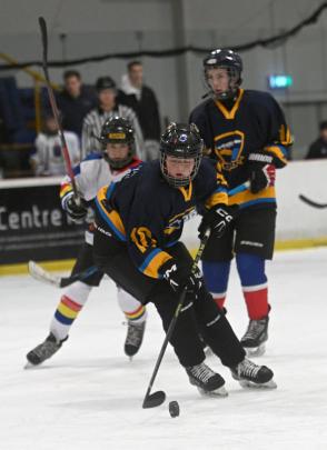 South Island schools ice hockey (Dunedin) - 	Wakatipu’s Aoife Orr controls the puck during a...