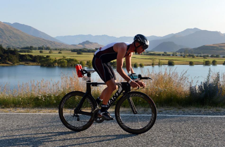 Ben Logan, of Wanaka, cycles past Paddock Bay.