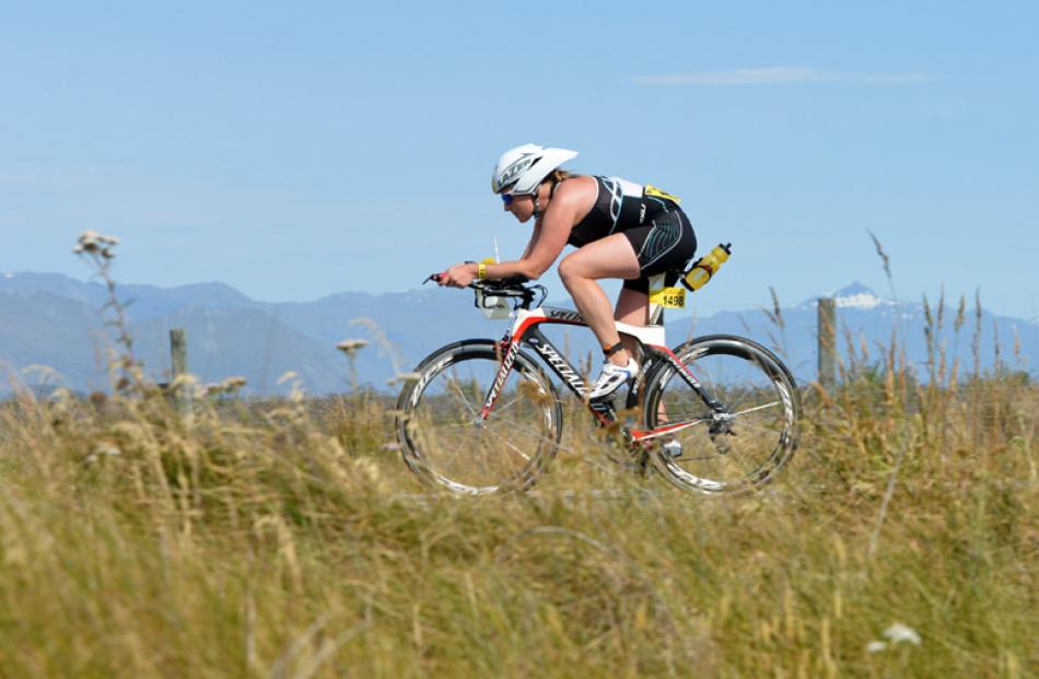 Andie Lowry, from Queenstown, scorches along Hawea Flat while competing in the individual half...