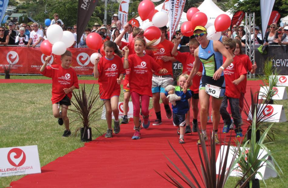 Albert Town athlete Gina Crawford runs up the Challenge Wanaka finishing chute in second place on...