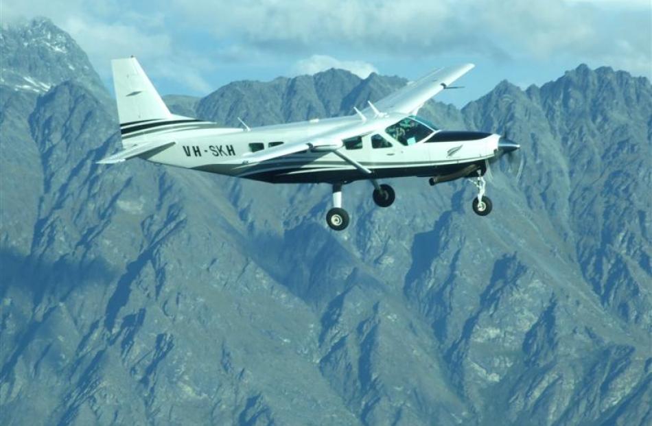 The Cessna with Hank and Antony Sproull on board flies  near the Remarkables as they arrive home...