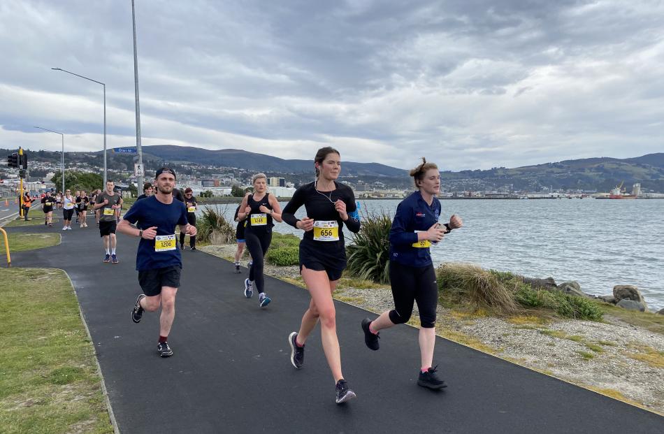 Half-marathon competitor Grace Wells (1357) is in the zone leading a pack along Portsmouth Dr...
