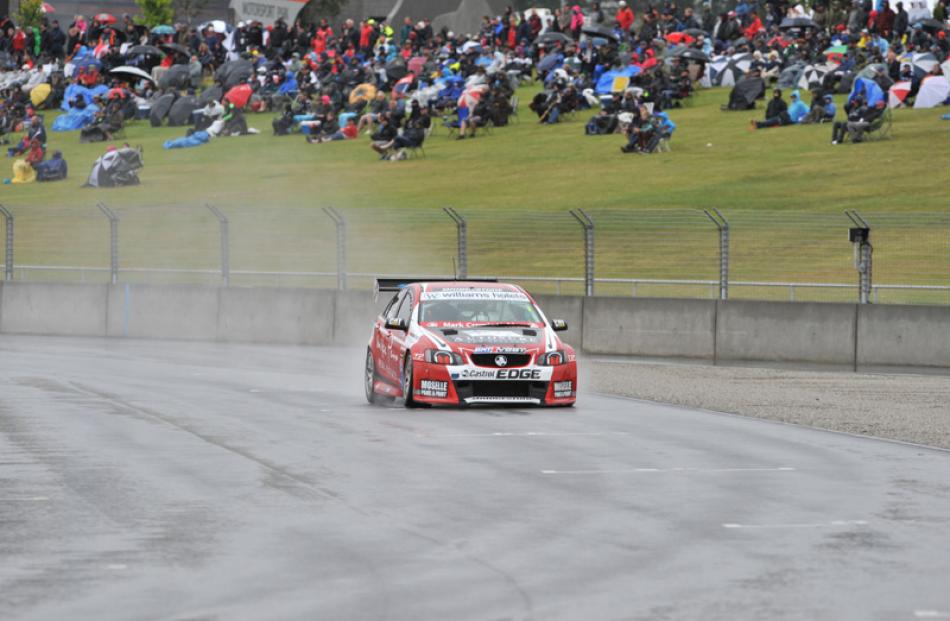 New Zealand driver Greg Murphy storms past the embankment in his Holden Commodore during the BNT...