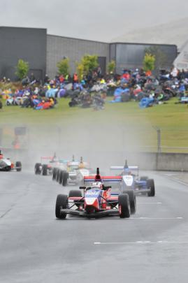 Cars enter the corner during their morning race.