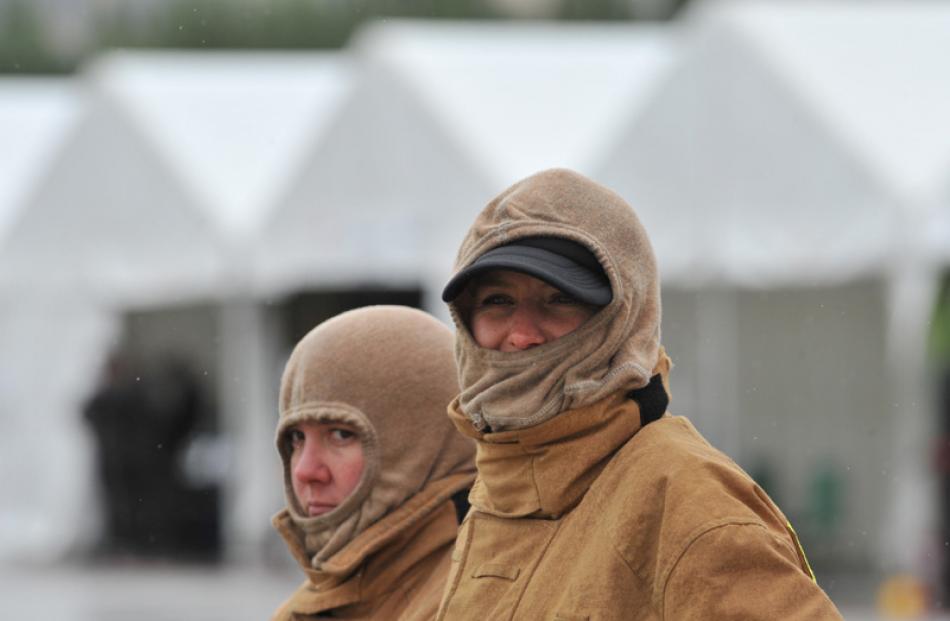 Volunteeer firefighters Tracey Hovenden (L), of Cromwell, and Ardouin Baker, of Wanaka, watch the...