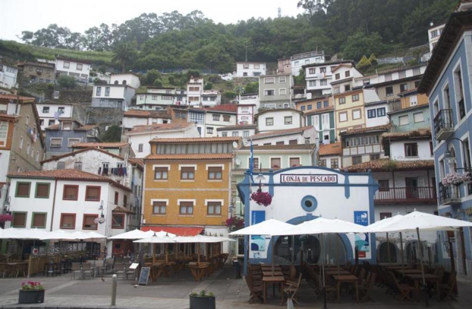 A patchwork of houses welcomes visitors to the Spanish port of Comillas along the Camino del...