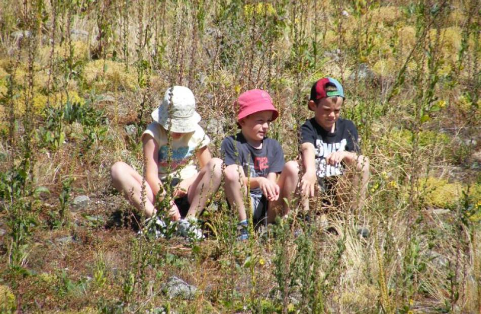 Spectators (from left) Cole Wells, George Reed (both of Tarras) and Ben Partridge, from England,...