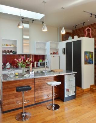 The kitchen island is faced with wall panelling from an office fit-out in the 1960s.